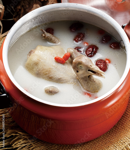 Gastrodia elata and pigeon soup in an orange stainless steel soup pot