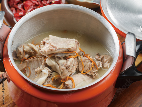 Cordyceps flower and old duck soup served in an orange stainless steel pot