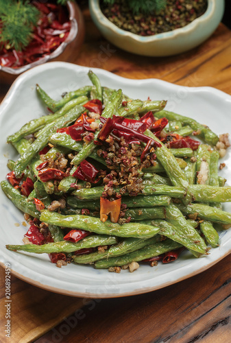 Stir-fried green beans served on a white porcelain plate
