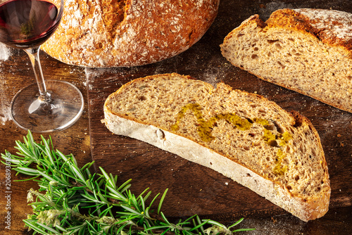 Homemade artisan sourdough bread loaf on a rustic wooden cutting board