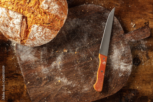 Homemade artisan sourdough bread loaf on a rustic wooden cutting board