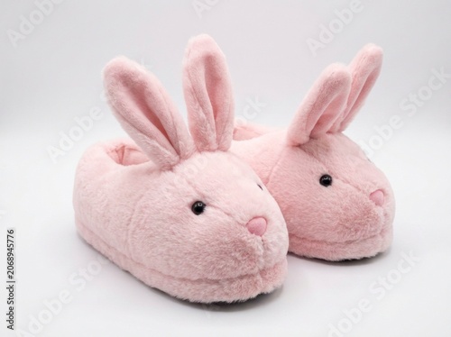 Pink bunny slippers resting on a white studio background with plush texture and sharp focus for loungewear retail advertising