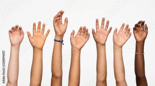 Multicultural arms gesturing upward against a white background with clean studio lighting for humanitarian aid and social outreach campaigns