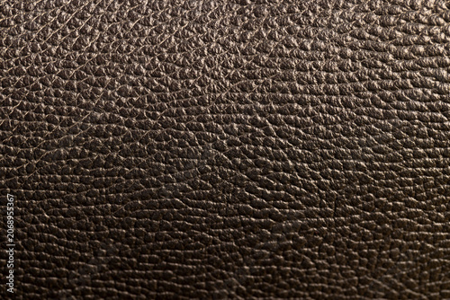 Foto details of a natural black leather bag after prolonged use, dark color