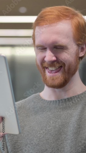 Portrait of Young Man Celebrating on Tablet in Office, Vertical Video