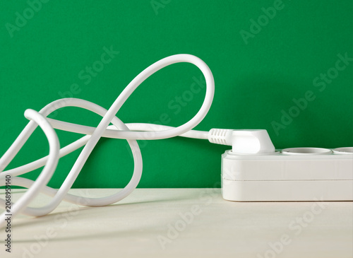 Tableau sur toile White power cable plugged into extension cord creating a knot