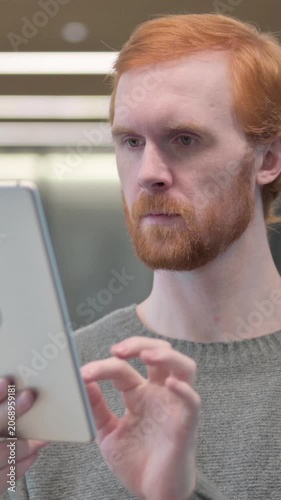Portrait of Attractive Young Man using Tablet in Office, Vertical Video