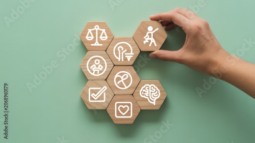 Hand arranging healthcare and wellness icons on pastel green background