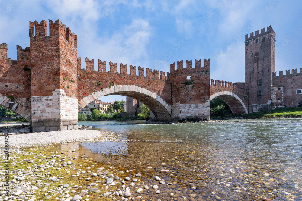 Obraz premium Medieval stone bridge Ponte Scaligero across the river Adige and tower of Castelvecchio in Verona, Italy.