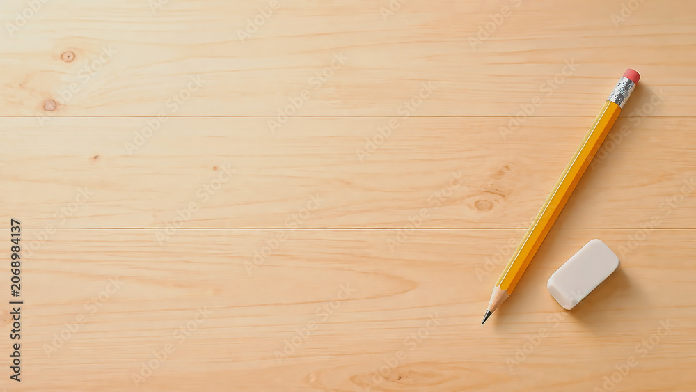 Obraz premium Pencil and Eraser on Wooden Desk with Copy Space, Education Background