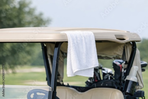 A golf cart with a towel on its roof, ideal for outdoor activities and sporting events