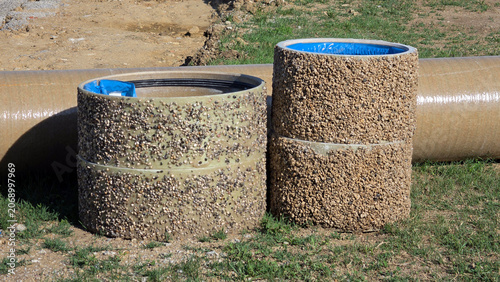 Konstfotografi Polymer concrete manhole riser rings with aggregate texture on a construction si