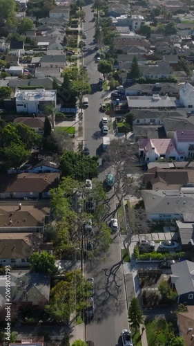 Forwards fly above rows of family houses in residential borough in Culver City. Los Angeles, California, USA