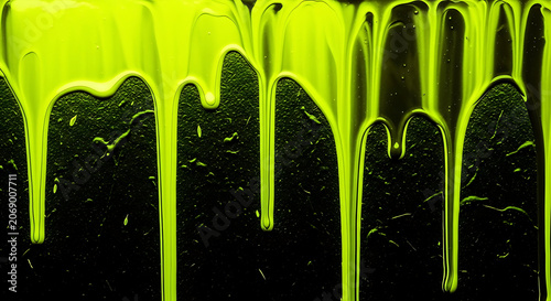 Vibrant neon green paint drips on dark background, abstract art design