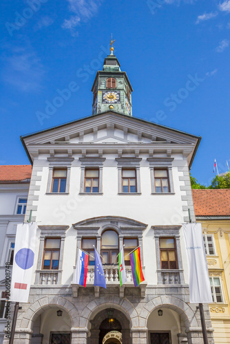Historic baroque facade of the town hall stands under a bright blue sky in Ljubljana, Slovenia