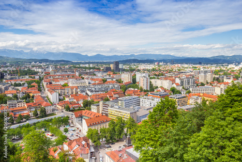 Scenic panoramic view stretches across the red rooftops and distant mountains of Ljubljana, Slovenia