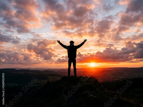 Silhouette of person celebrating sunset victory.