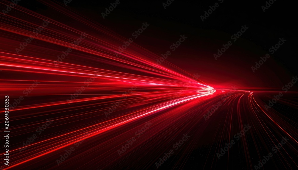 Fototapeta premium Red light trails on a dark background, suggesting speed and movement.