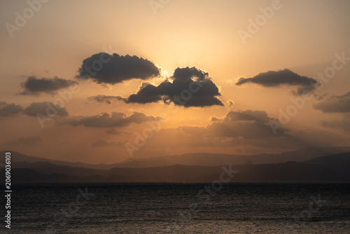 Canvas Print Dramatic sunrise with crepuscular rays over Kinko Bay