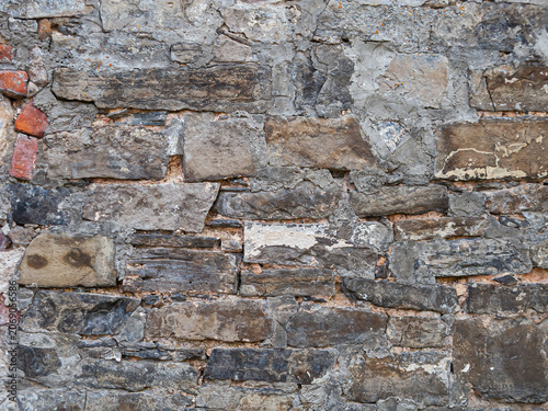 Wall made of rough stones showing different textures and colors in a construction setting
