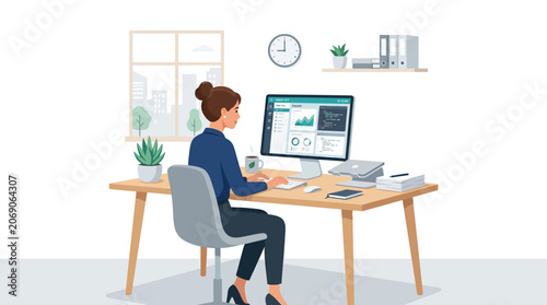 Businesswoman Working on Computer at Desk in Modern Office