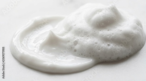 White Cosmetic Foam and Smooth Cream Smear Texture on Light Background