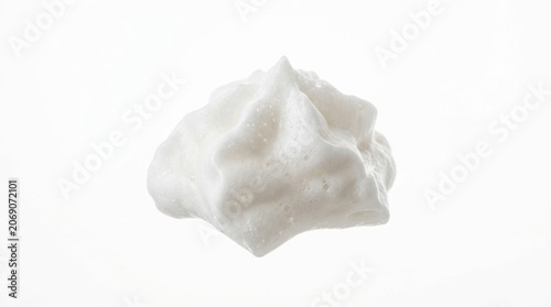 White foam swirl isolated on white background, whipped cream dollop macro shot