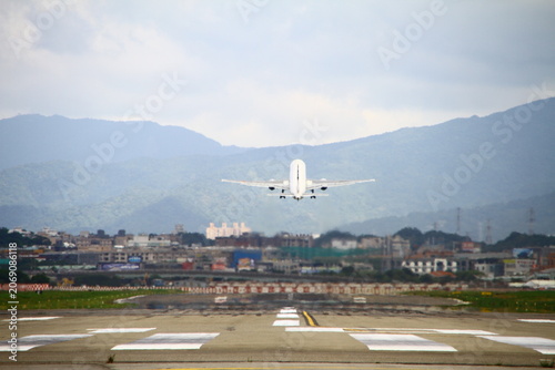 A commercial passenger jet takes off from the runway.