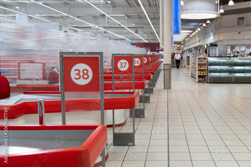 Bild auf Leinwand Empty supermarket checkout counters stand in a row inside a commercial retail grocery store
