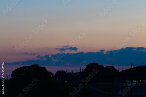 Pastel twilight sky above silhouetted town landscape