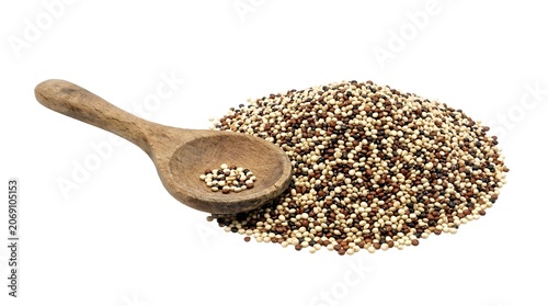 A wooden spoon rests on a pile of quinoa seeds, ready for preparation. The quinoa is a mix of white, red, and black seeds, promising a healthy and versatile ingredient