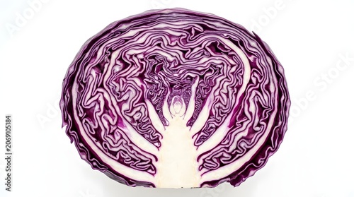A halved red cabbage with intricate layers and vibrant purple hues, revealing its fresh texture