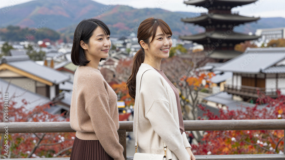 Fototapeta premium Enjoying Panoramic Autumn View from Traditional Japanese Tower, Cowboy shot, Copy space on the right