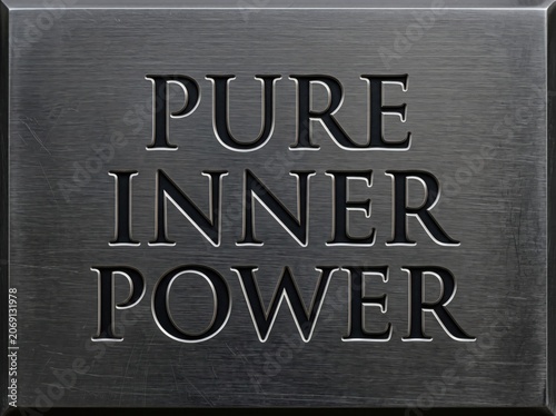 Engraved metal plate with the words pure inner power in a metallic font