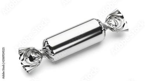 A shiny silver wrapped candy resting on a white background