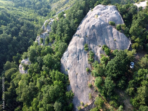 Aerial view of Sasso di Sant'Andrea, a prominent sandstone geological feature surrounded by dense forest. Zocca, Modena, Emilia-Romagna, Italy