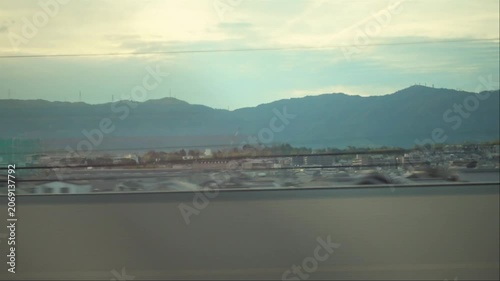 view of casual city and hills from moving fast express train window, Japan, Kobe, copy space