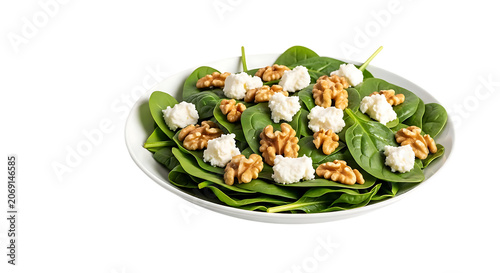 A salad with a plate on a black background, spinach salad, walnuts