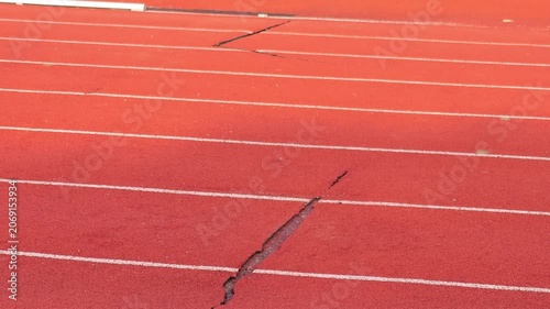 The damaged athletics track and field  , sports field.