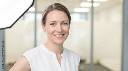 A bright, high-key head-and-shoulders portrait of a professional business woman