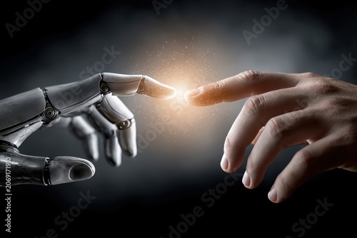Close-up of a human finger and a robotic hand reaching out to touch, symbolizing AI and humanity connection.
