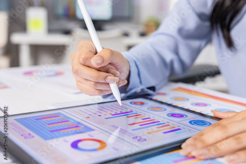 Digital tablet stylus chart business analysis report data hand office graph close up of professional working on financial infographic dashboard with calm focus