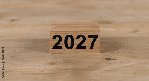A wooden cube displays the year 2027 within a business planning context � Professional Stock Photography Concept for Commercial and Marketing Use