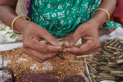 Hands Rolling Traditional Leaf Bidis with Tobacco by Hand