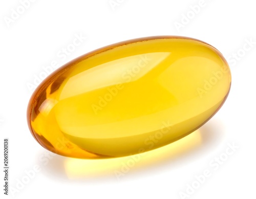 Single transparent yellow gel capsule on white background