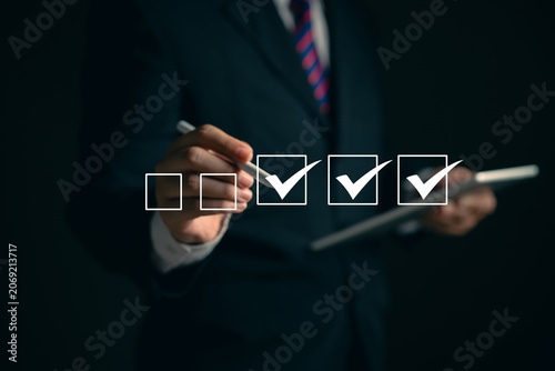 oung business woman using laptop surveys online checklist Complete the digital form checklist via the internet..Business performance checklist concept Y