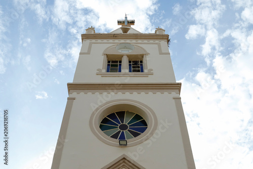 Bell tower of Saint Francis of Assis church against blue sky in Vargem Bonita