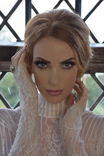 Obraz na plátně Beautiful, tall, shapely redhead model in lace lingerie, posing in front of a wi