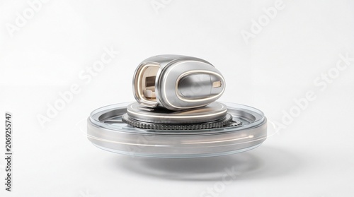 Futuristic metallic pod on a mechanical turntable against a white background
