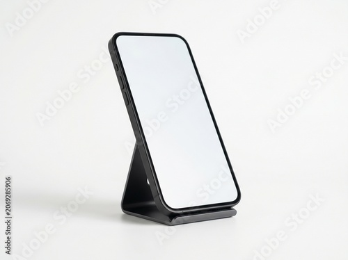 Black smartphone on a stand isolated on white background